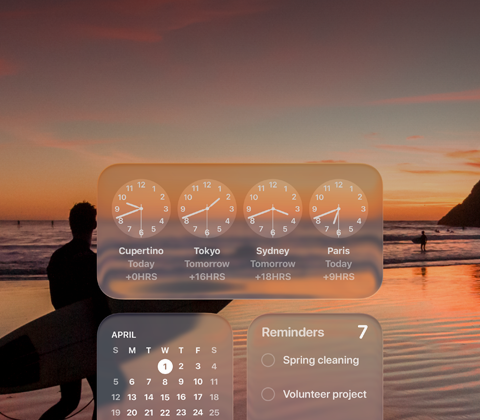 Liquid Glass widgeti Sat, Kalendar, Podsjetnici i Vrijeme na zaslonu macOS Tahoe preko prizora surfera koji hoda plažom u zalazak sunca